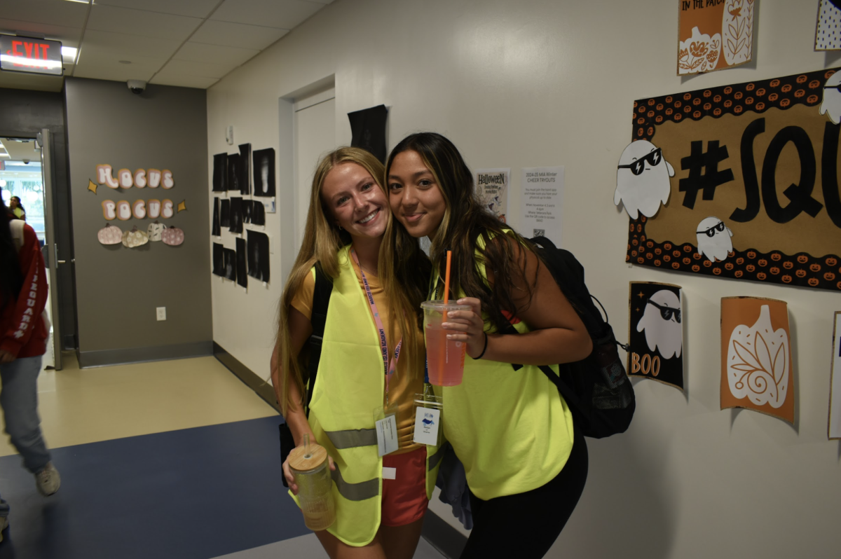 Jessica Vorderstrasse (left) and Ayleen Abin (right) posing for a photo decked out in neon gear.